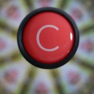 Red logo disc on golf umbrella
