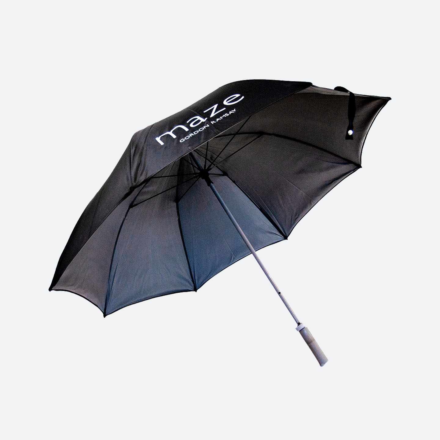 Side view of black umbrella with white Maze logo