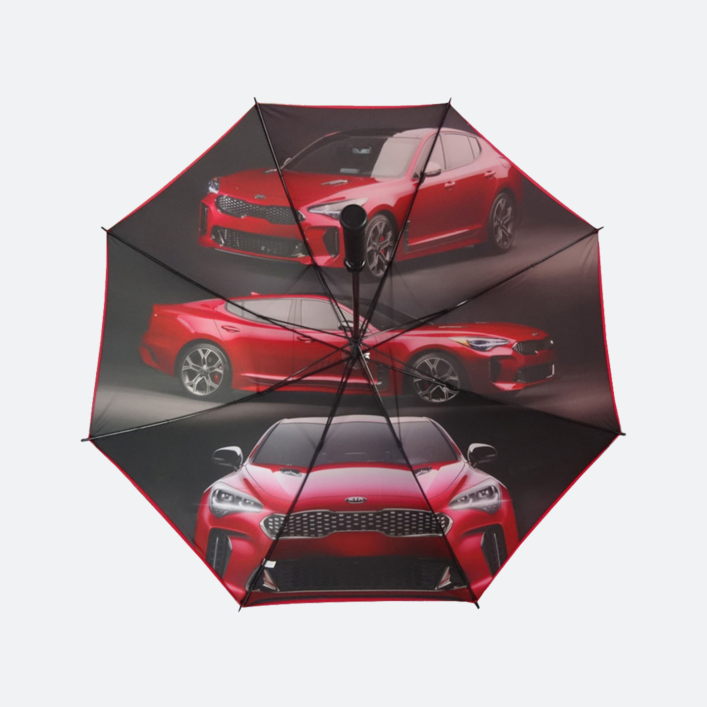 Inner view of a black umbrella with a photographic red car design