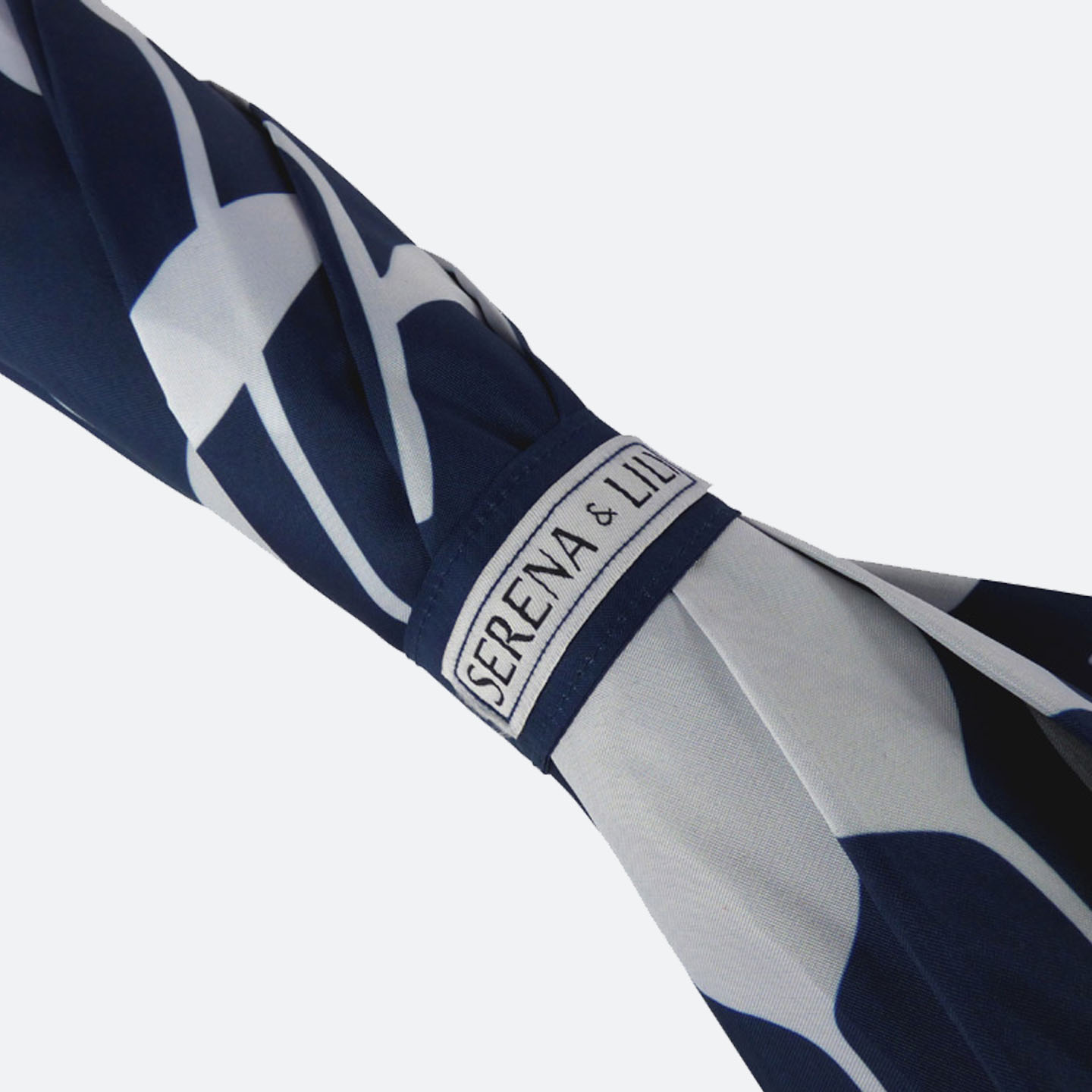 Close up of an closed umbrella tie wrap that is navy and white