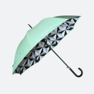side view of walking umbrella with curve black handle and print on inside and outside of the umbrella