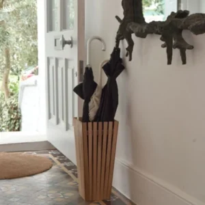 Black and white umbrellas in umbrella stand in entryway of house