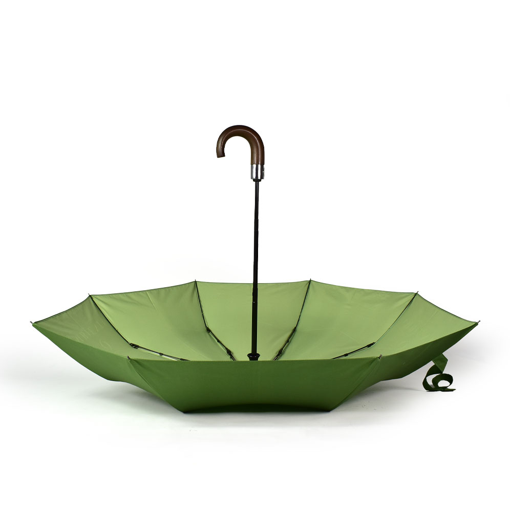 open green umbrella upside down with wooden curved handle