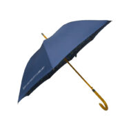 open university umbrella on the side with blue umbrella panels and wooden pole and curved handle