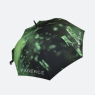 Fabergé printed umbrella in green showing the top view of the umbrella