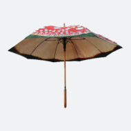 side view of umbrella that looks like a mushroom with red outer canopy and cream inside print artist’s illustration printed on umbrella