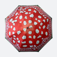 artist’s illustration printed on umbrella of mushroom shows top of umbrella with it open with red panels and white mishappen spots