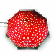 Open umbrella for Bristol Fungarium with red panels and mushroom pattern with wooden pole and curved handle