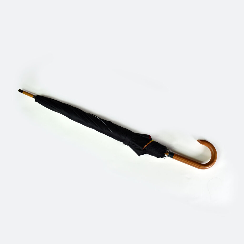 closed umbrella tied with tie wrap and wooden tip and curved handle