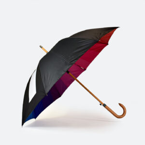 side view of rainbow umbrella with black external panels showing the inside rainbow print