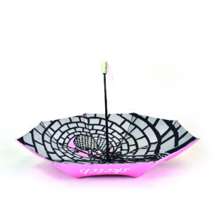 upside down open folding umbrella with pink outside panels plus black and white inside panels printed