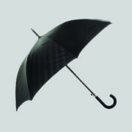tone on tone print on black canopy umbrella with curved handle on white background