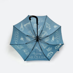 open view of blue panels of an umbrella with show through of white print include a sausage dog print on umbrella