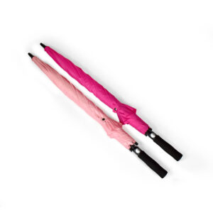two closed umbrellas tied with their tie wraps in baby pink and hot pink with black handles