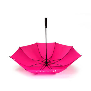 upside down open view of large golf umbrella with hot pink panels and white logo print