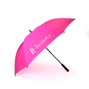 side view of open hot pink premium branded umbrella with white Harrods logo print on one panel