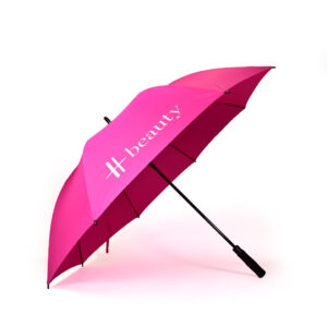 side view of open hot pink premium branded umbrella with white Harrods logo print on one panel